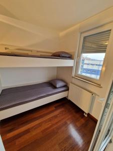 a small room with two bunk beds and a window at Apartment Matea in Pula