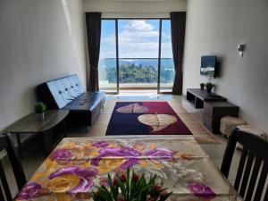 a living room with a table and a large window at Relax Bear Homestay in Tanah Rata +288 photos