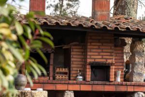a brick building with a fireplace in the middle at Casa Senhor da Ponte in Mondim de Basto