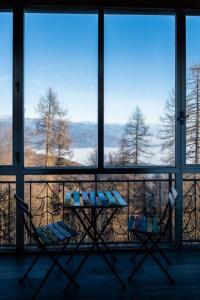 a balcony with two chairs and a view of the mountains at La casa sul Monviso in Montoso