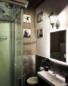 a bathroom with a glass shower and a sink at Le Stanze di Marco in Monza