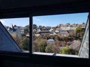 a window with a view of a city at Le studio 19 in Saint-Cast-le-Guildo