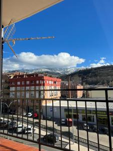 a view of a city from a balcony with a train at El Balcón de la Covatilla in Béjar