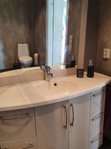 a bathroom with a sink and a mirror at Molden 1 - med Jacuzzi! in Luster