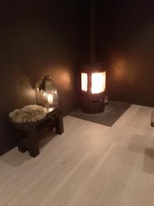 a dark room with a bench and a lantern at Molden 1 - med Jacuzzi! in Luster