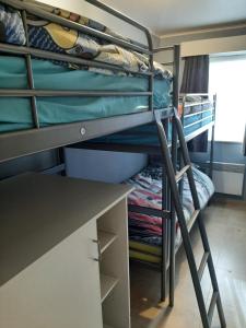 a dorm room with bunk beds and a desk at House Kimberly 194, bus 102 in Nieuwpoort +11 photos