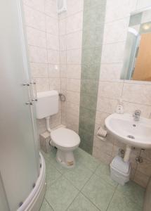 a bathroom with a toilet and a sink at Guest House Maria in Međugorje