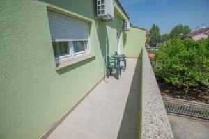 a patio with two chairs and a table on the side of a building at Guest House Maria in Međugorje