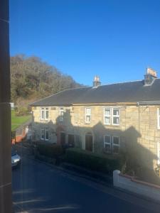 a large brick house on a street at DunMoore Guesthouse in Oban