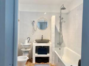 a bathroom with a sink and a bath tub at Casa da Aldeia in Santa Bárbara de Nexe +67 photos