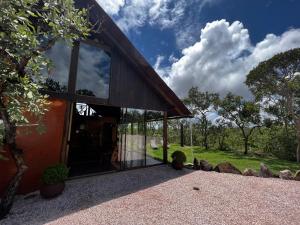 a barn conversion with glass windows and trees at Rancho Aroeira in Sao Jorge