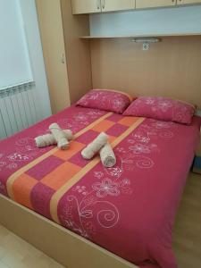 a bed with two towels and two pillows on it at Apartments & Rooms Villa Adamović in Umag