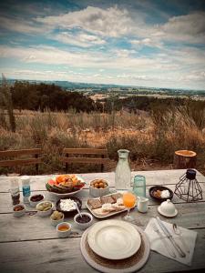 a wooden table with plates of food on it at Chateau de Cours in Sénezergues