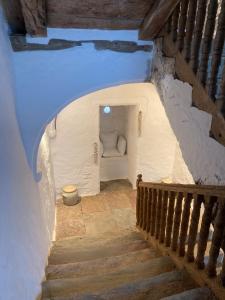 an attic room with a staircase in a building at Chateau de Cours in Sénezergues