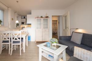 a living room with a couch and a table at Ferienwohnung Frahm in Hörnum +10 photos
