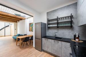 a kitchen with a sink and a table in a room at Astronomical Clock Apartment in Prague