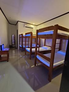 a room with three bunk beds in it at CocoVille Guesthouse in Alegria