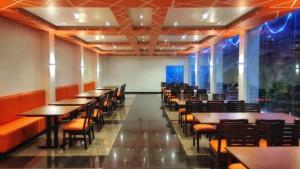 a row of tables and chairs in a restaurant at Belair Resorts in Kotagiri