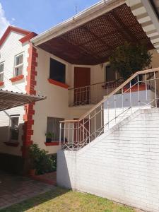 a brick building with a staircase on the side of it at Apartamento Aeropuerto La Aurora Guatemala in Guatemala