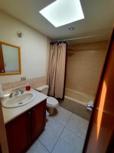 a bathroom with a sink and a toilet and a shower at Apartamento Aeropuerto La Aurora Guatemala in Guatemala