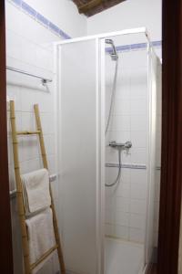 a shower with a glass door in a bathroom at Casa Refúgio in Évora