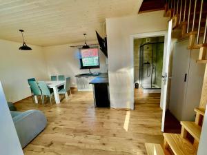 a kitchen and dining room with a table and chairs at Apartament na Ogrodowej - 2 sypialnie, ogród, taras, parking in Trzęsacz
