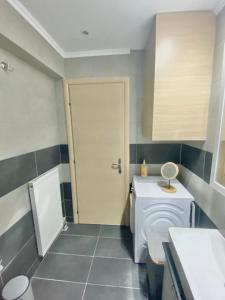 a bathroom with a white toilet in a room at Little John Luxury Apartment in Piraeus