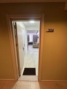 an open door to a living room with a door mat at New Gudauri, Hotel Peak in Gudauri