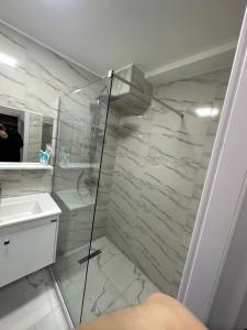 a bathroom with a glass shower and a sink at New Gudauri, Hotel Peak in Gudauri