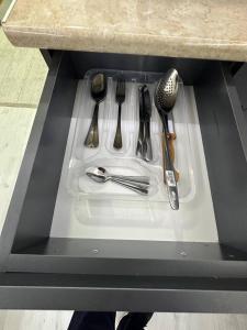 a drawer in a counter with utensils on it at New Gudauri, Hotel Peak in Gudauri