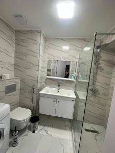 a bathroom with a sink and a toilet and a shower at New Gudauri, Hotel Peak in Gudauri +8 photos