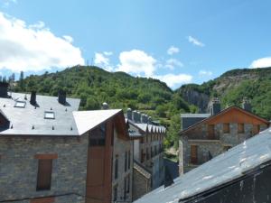a view of a city with buildings and a mountain at La buhardilla de Mayte in Broto