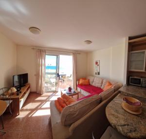 a living room with a couch and a table at Casa Sara in Costa Calma
