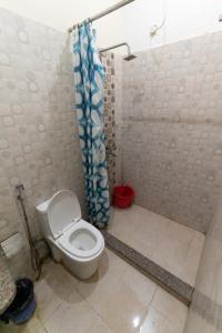 a bathroom with a toilet and a shower at The Century Plaza Hotel in Varanasi