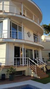 a large building with a balcony and stairs on it at Casa con vistas al mar in Castelldefels