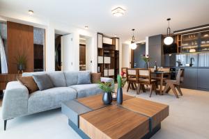 a living room with a couch and a table at EZ Luxury Living in Rovinj