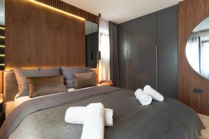 a bedroom with a large bed with two towels on it at EZ Luxury Living in Rovinj