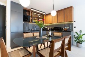 a dining room and kitchen with a glass table and chairs at EZ Luxury Living in Rovinj +25 photos