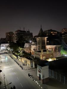 uma cidade à noite com uma rua e edifícios em شقة هادئة في الزمالك no Cairo