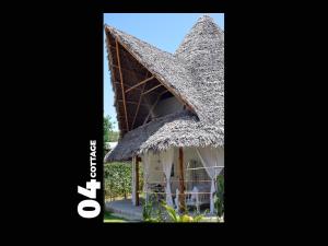 a house with a thatched roof at 04 beach cottage malindi in Malindi