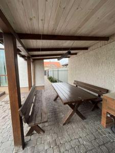 a wooden bench on a patio with a wooden ceiling at Maxim in Vinnytsya