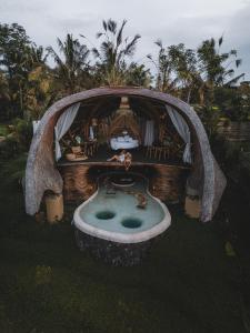 a small house with a pool in the yard at Veluvana Bali in Sidemen