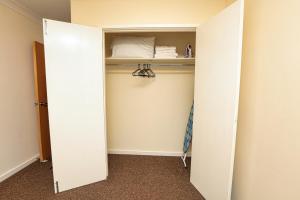 a room with a closet with a white door at SureSpring Apartment in Slades Green