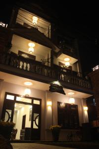 a building with lights on the side of it at night at Hoi An Viet House Homestay in Hoi An
