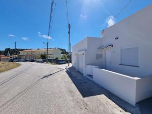 a white building on the side of a street at Natura House in Aveiro