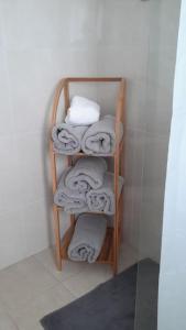 a bunch of towels on a towel rack in a bathroom at Helena House in Senhora da Hora
