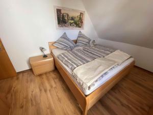 a small bed in a room with a wooden floor at Kleine Elbequelle in Wolfhagen