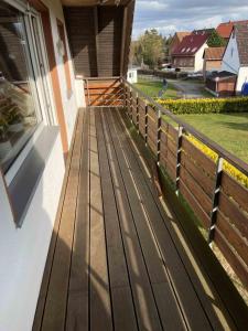 a wooden deck on the side of a house at Kleine Elbequelle in Wolfhagen