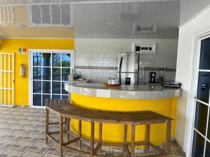 a kitchen with a yellow and white counter top at Posada buena vista al mar in Providencia