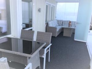 a balcony with chairs and a couch and a table at Ailo in Inari